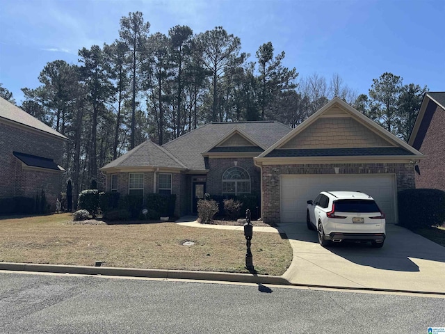 craftsman-style house featuring a garage, a front yard, brick siding, and driveway