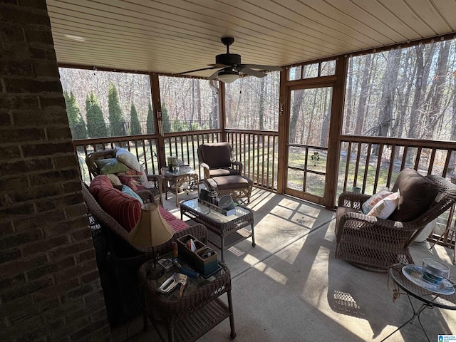 sunroom featuring a ceiling fan and a wealth of natural light