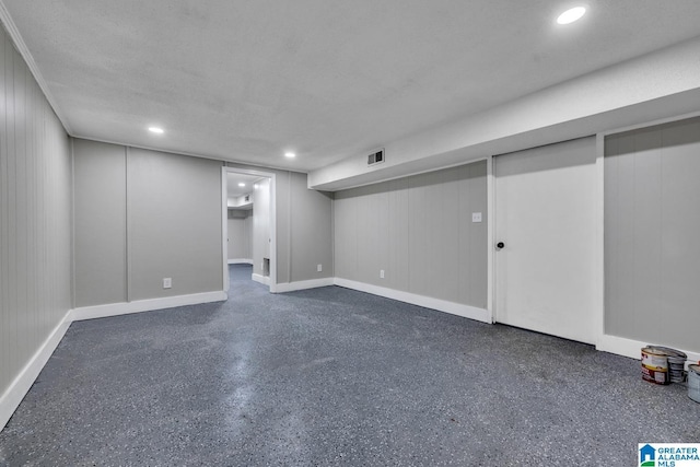 finished basement with baseboards, visible vents, a textured ceiling, and recessed lighting