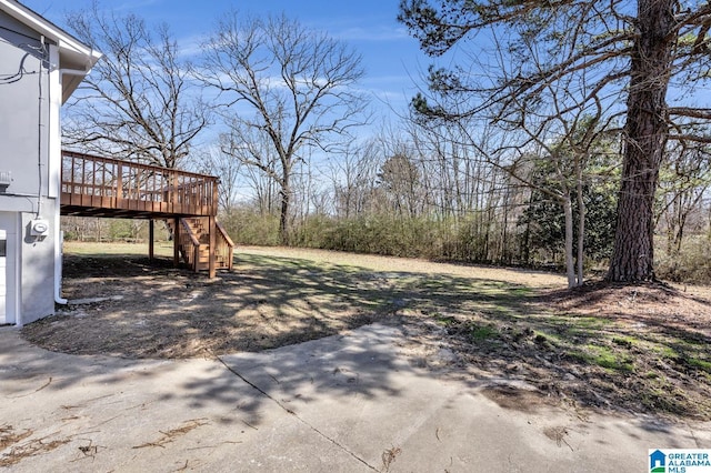 view of yard with stairway and a wooden deck