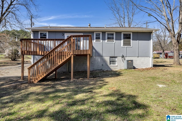 back of property featuring stairs, a deck, and a yard