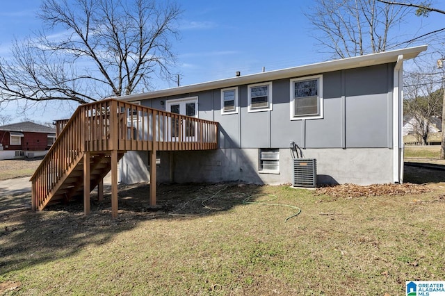 back of house with stairway, a lawn, and a deck