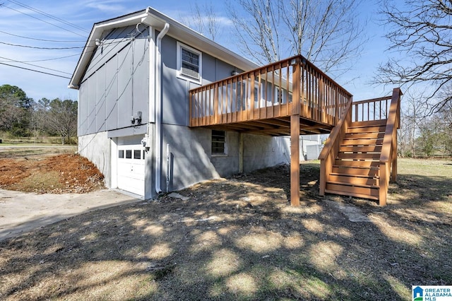 rear view of house with stairway and a wooden deck