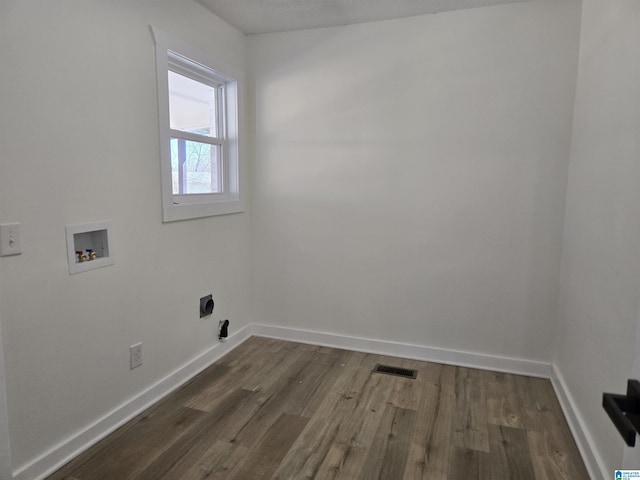 laundry area with laundry area, dark wood-type flooring, washer hookup, and visible vents