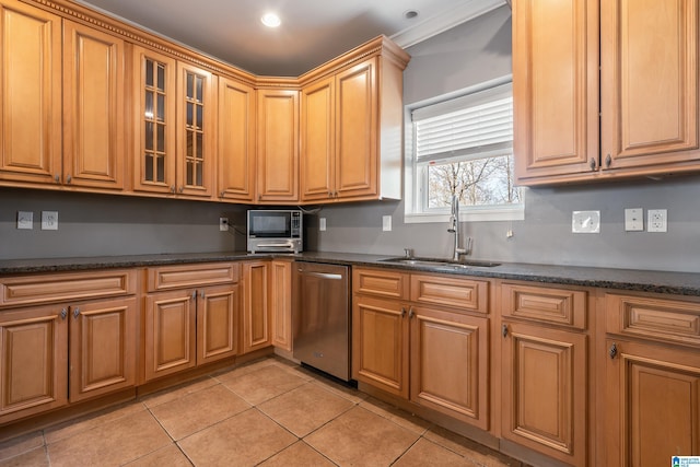 kitchen with dishwasher, dark stone countertops, a sink, and glass insert cabinets