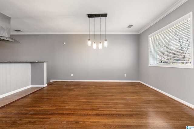 unfurnished dining area featuring baseboards, visible vents, dark wood finished floors, and ornamental molding