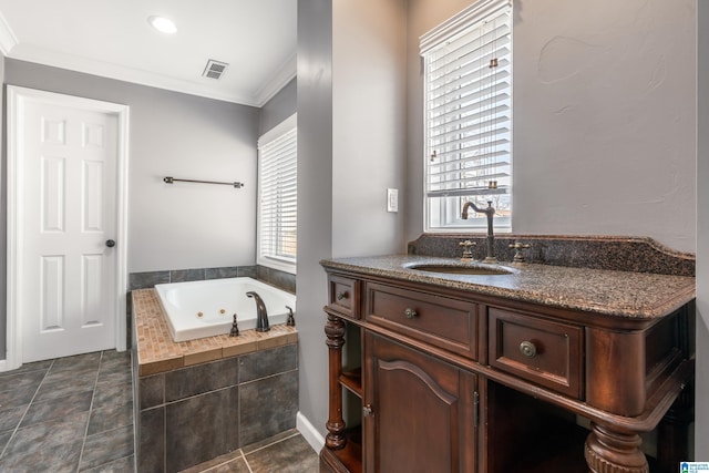 bathroom with visible vents, ornamental molding, vanity, a jetted tub, and tile patterned floors