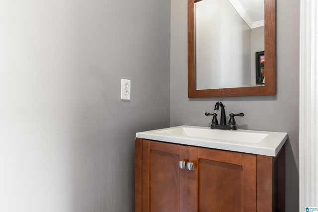 bathroom with crown molding and vanity