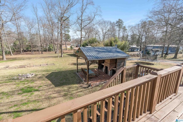 deck featuring a trampoline and a yard