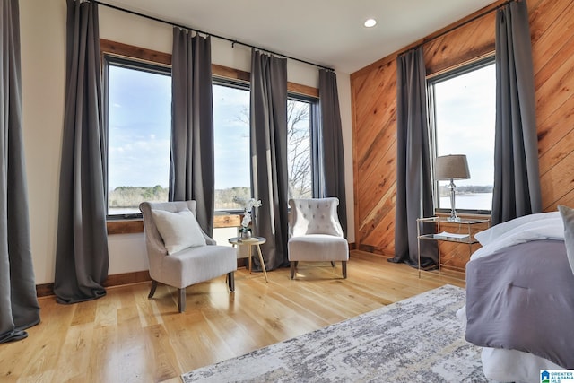 sitting room featuring light wood-style floors, recessed lighting, and a water view