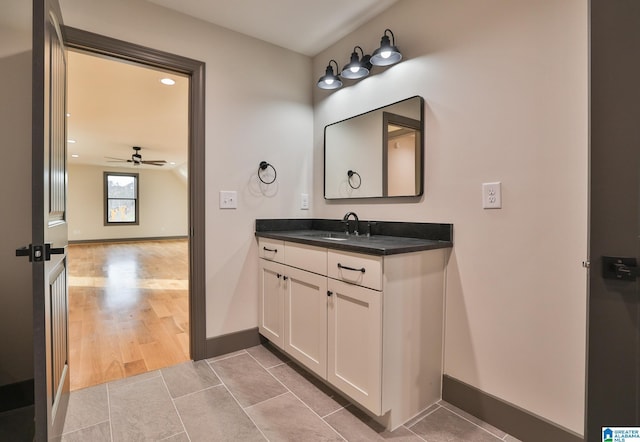 bathroom featuring a ceiling fan, tile patterned flooring, vanity, and baseboards