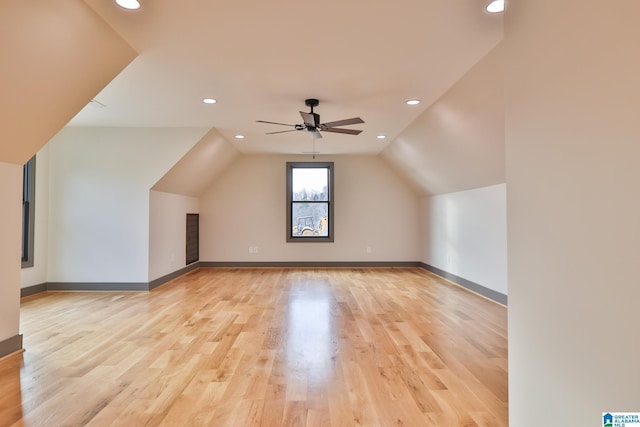 additional living space with recessed lighting, vaulted ceiling, ceiling fan, light wood-type flooring, and baseboards