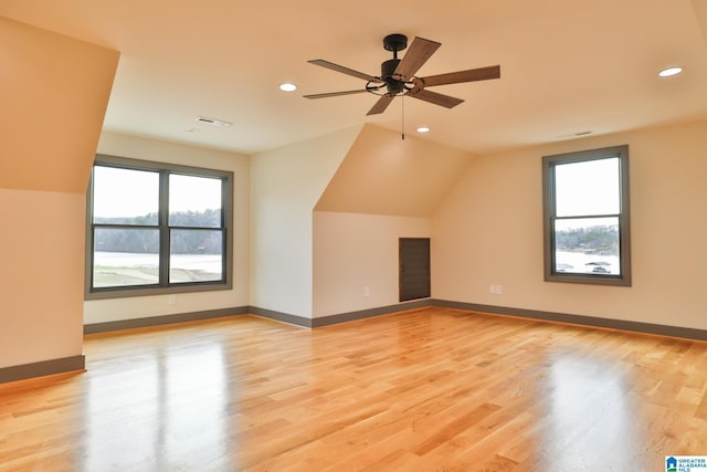 bonus room featuring light wood finished floors, visible vents, and baseboards