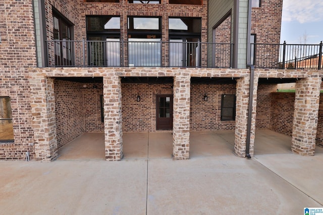 back of house featuring brick siding