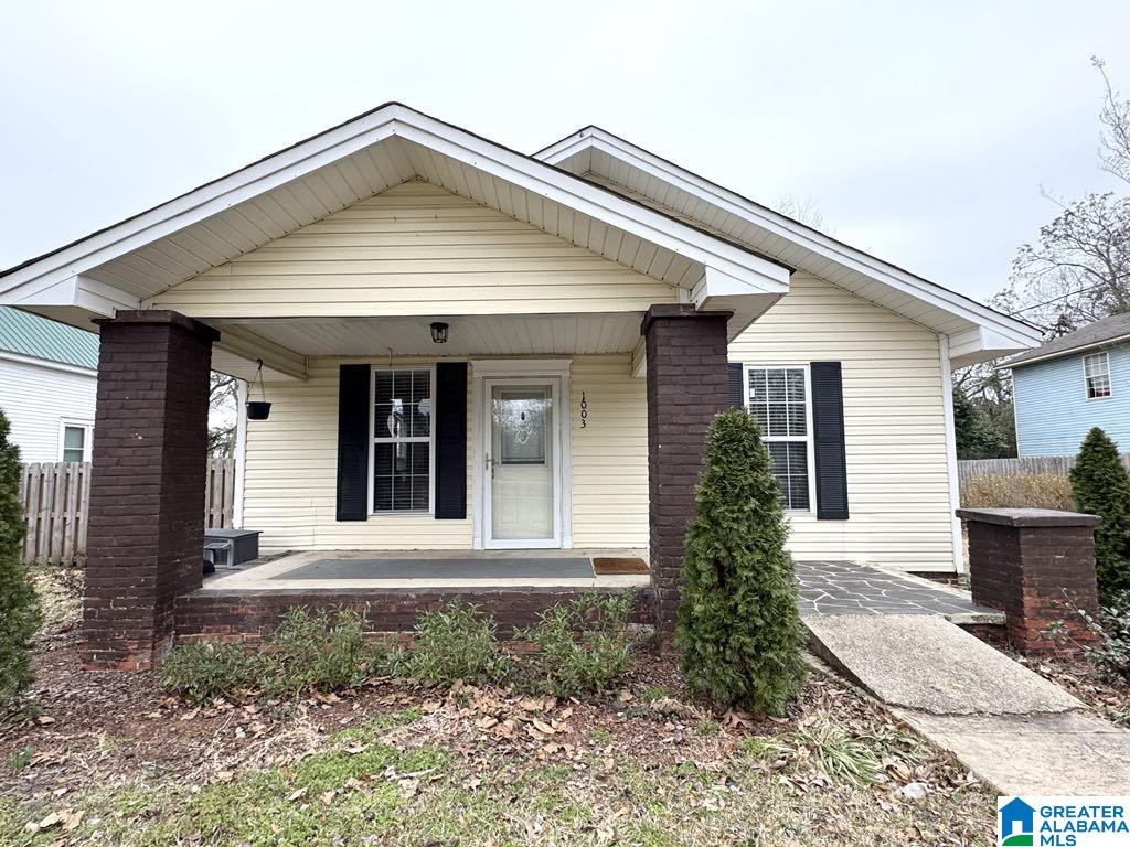 bungalow featuring fence and a porch