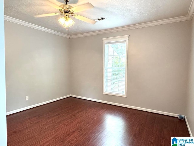 1003 2nd Ave N, Clanton, AL 35045 - spare room featuring dark wood-style flooring, a ceiling fan, baseboards, a textured ceiling, and crown molding