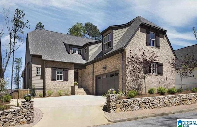 view of front facade featuring a garage, concrete driveway, and brick siding