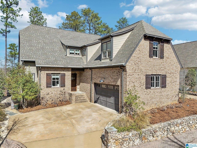 view of front of house with a garage, brick siding, driveway, and roof with shingles