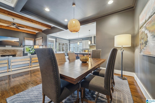 51 Nolen St, Birmingham, AL 35242 - dining room featuring baseboards, dark wood finished floors, crown molding, a fireplace, and beam ceiling