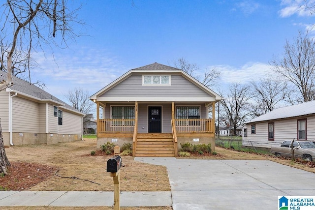 bungalow featuring a porch, crawl space, and roof with shingles