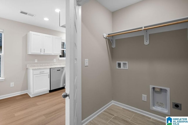 laundry area featuring hookup for a washing machine, laundry area, visible vents, light wood finished floors, and electric dryer hookup