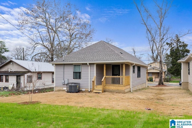 back of property with central AC and a shingled roof