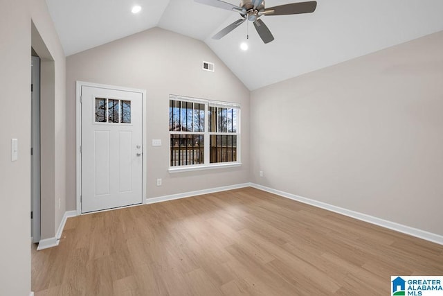 foyer with a ceiling fan, baseboards, vaulted ceiling, visible vents, and light wood-style floors