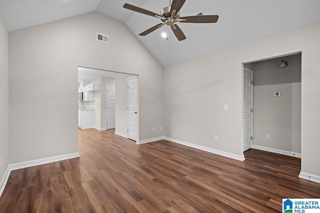 unfurnished bedroom featuring vaulted ceiling, visible vents, dark wood finished floors, and baseboards