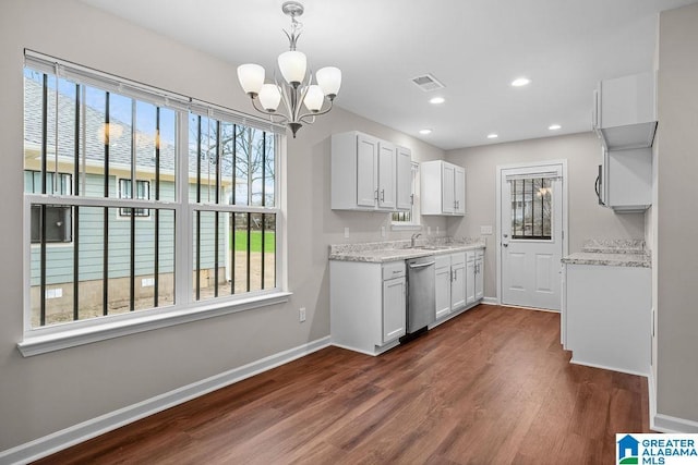 kitchen featuring visible vents, white cabinets, dark wood-type flooring, pendant lighting, and stainless steel dishwasher