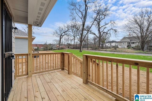 deck featuring a residential view and a lawn