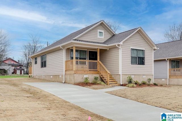 view of front of house featuring a shingled roof, crawl space, and a porch