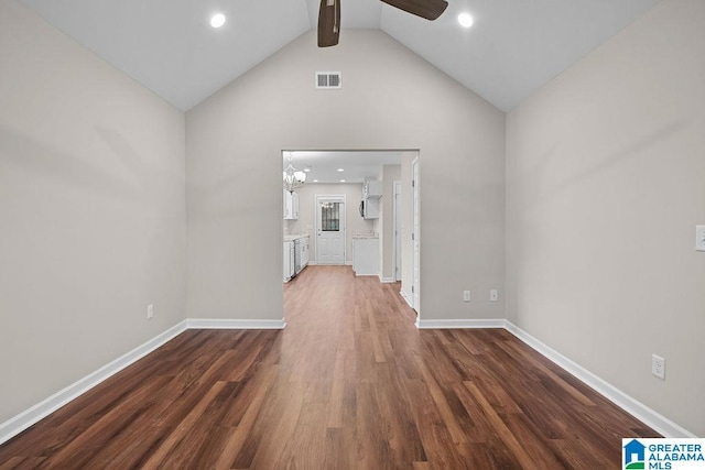 unfurnished room featuring baseboards, visible vents, dark wood-type flooring, and ceiling fan with notable chandelier