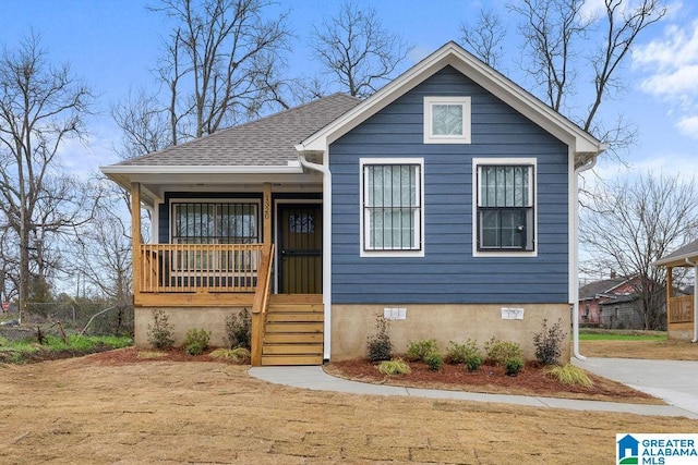 bungalow-style house with a shingled roof, crawl space, and covered porch