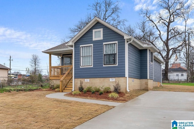 bungalow-style home with crawl space, covered porch, and stairs