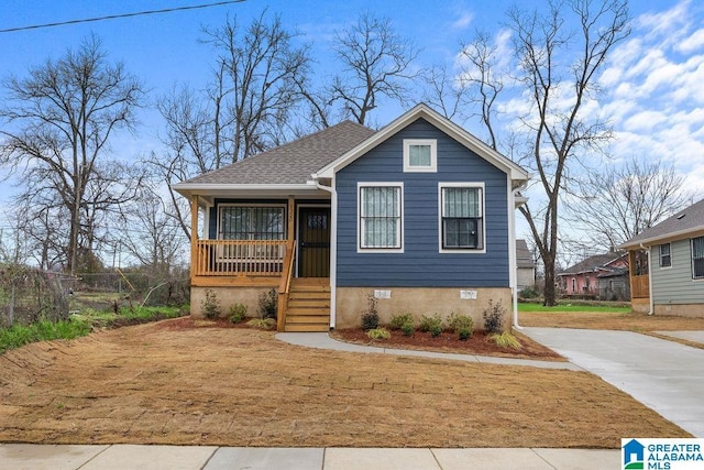 bungalow-style home with roof with shingles, a porch, and crawl space