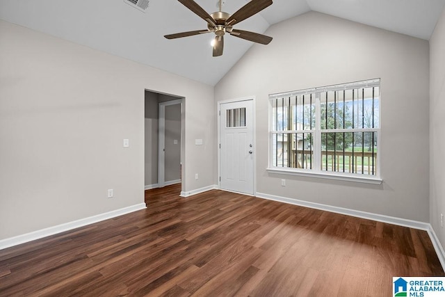 spare room featuring high vaulted ceiling, dark wood finished floors, a ceiling fan, and baseboards