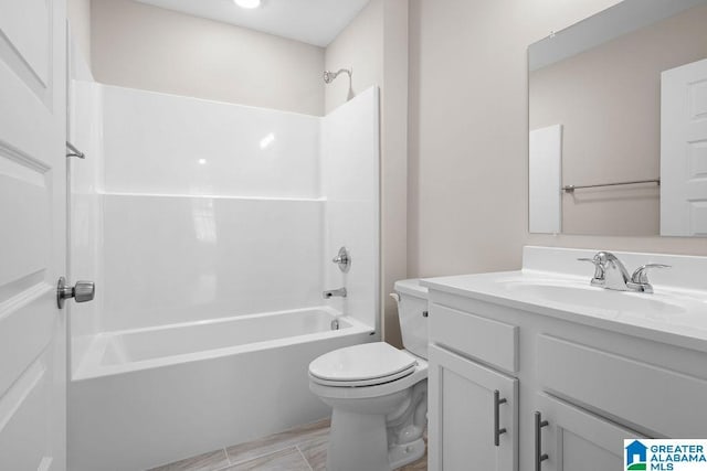 bathroom featuring toilet, washtub / shower combination, and vanity