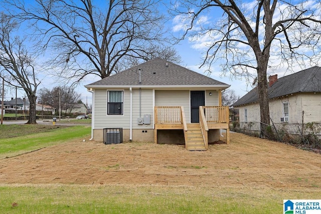 back of property featuring a shingled roof, a lawn, crawl space, fence, and a wooden deck