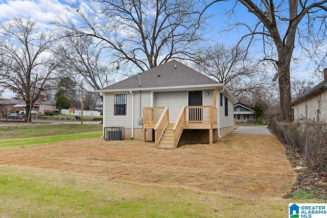 rear view of property featuring roof with shingles