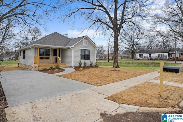 view of front of property featuring a porch, a front yard, crawl space, and a shingled roof