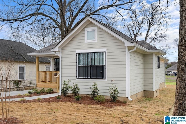 bungalow featuring covered porch and a shingled roof