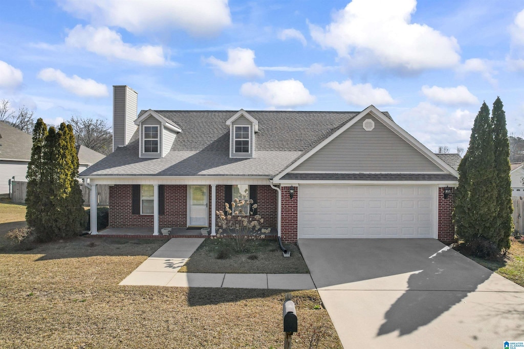 view of front of home featuring a porch, brick siding, driveway, and an attached garage