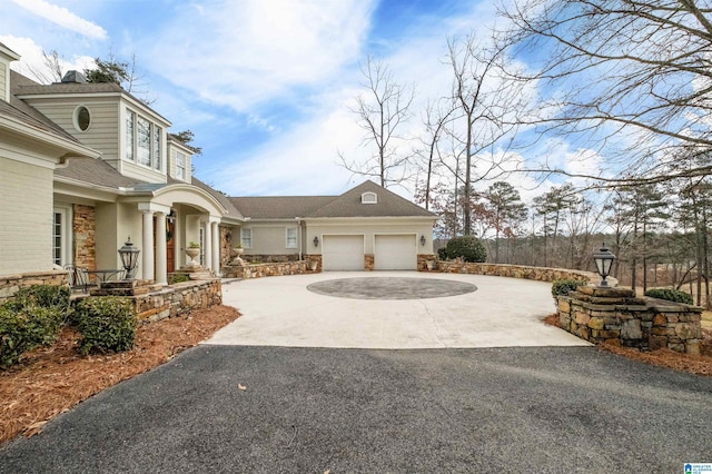 view of side of home featuring driveway and an attached garage