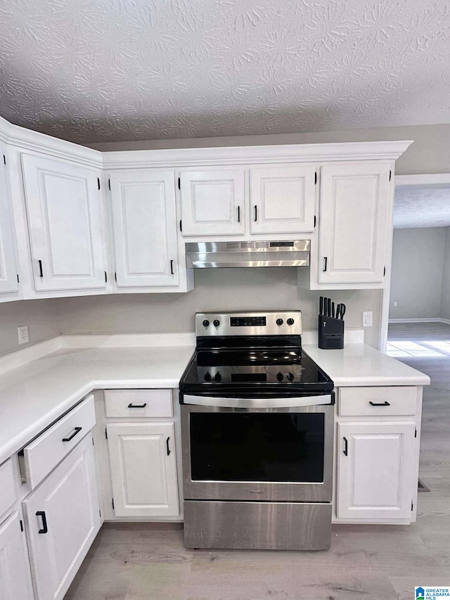 kitchen featuring under cabinet range hood, white cabinets, electric stove, light countertops, and light wood-type flooring