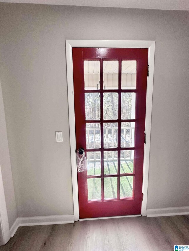 entryway featuring wood finished floors and baseboards