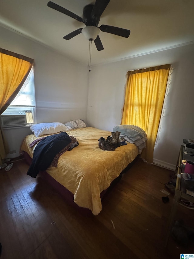 bedroom featuring a ceiling fan, dark wood finished floors, and cooling unit