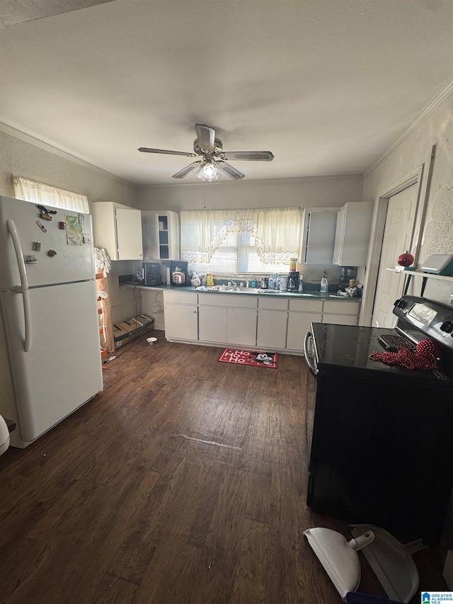 kitchen featuring electric range, white cabinetry, freestanding refrigerator, dark wood finished floors, and crown molding