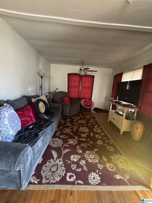 living area with ceiling fan and wood finished floors