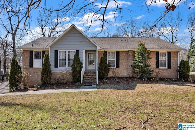 single story home with roof with shingles, a front yard, and brick siding