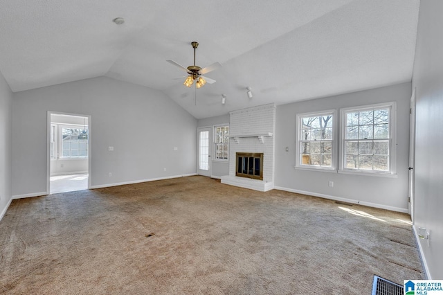 unfurnished living room featuring visible vents, a fireplace, carpet flooring, and ceiling fan